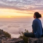Chinese Medicine practitioner meditating on mountain